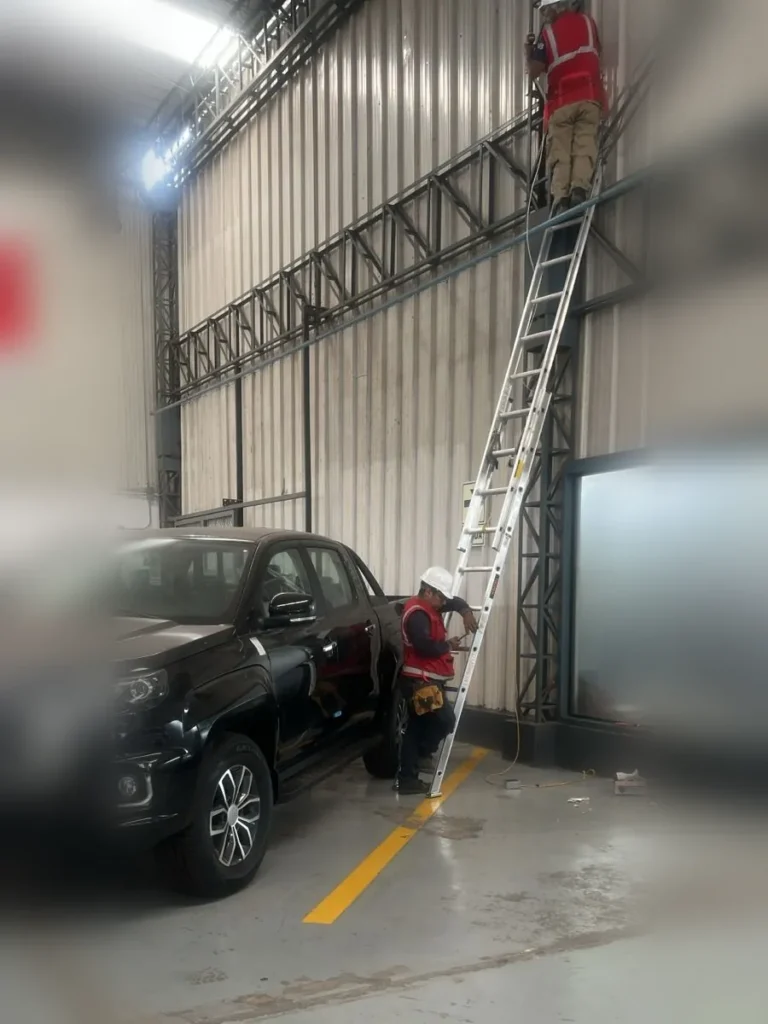 Videovigilancia con 15 cámaras Dahua para Maquisistemas 4 Técnicos con casco y arnés instalando tubería conduit en altura en Maquisistemas